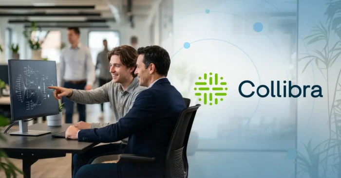 Two professionals reviewing a data governance workflow on a monitor, representing the top 5 Collibra experts and implementation partners.